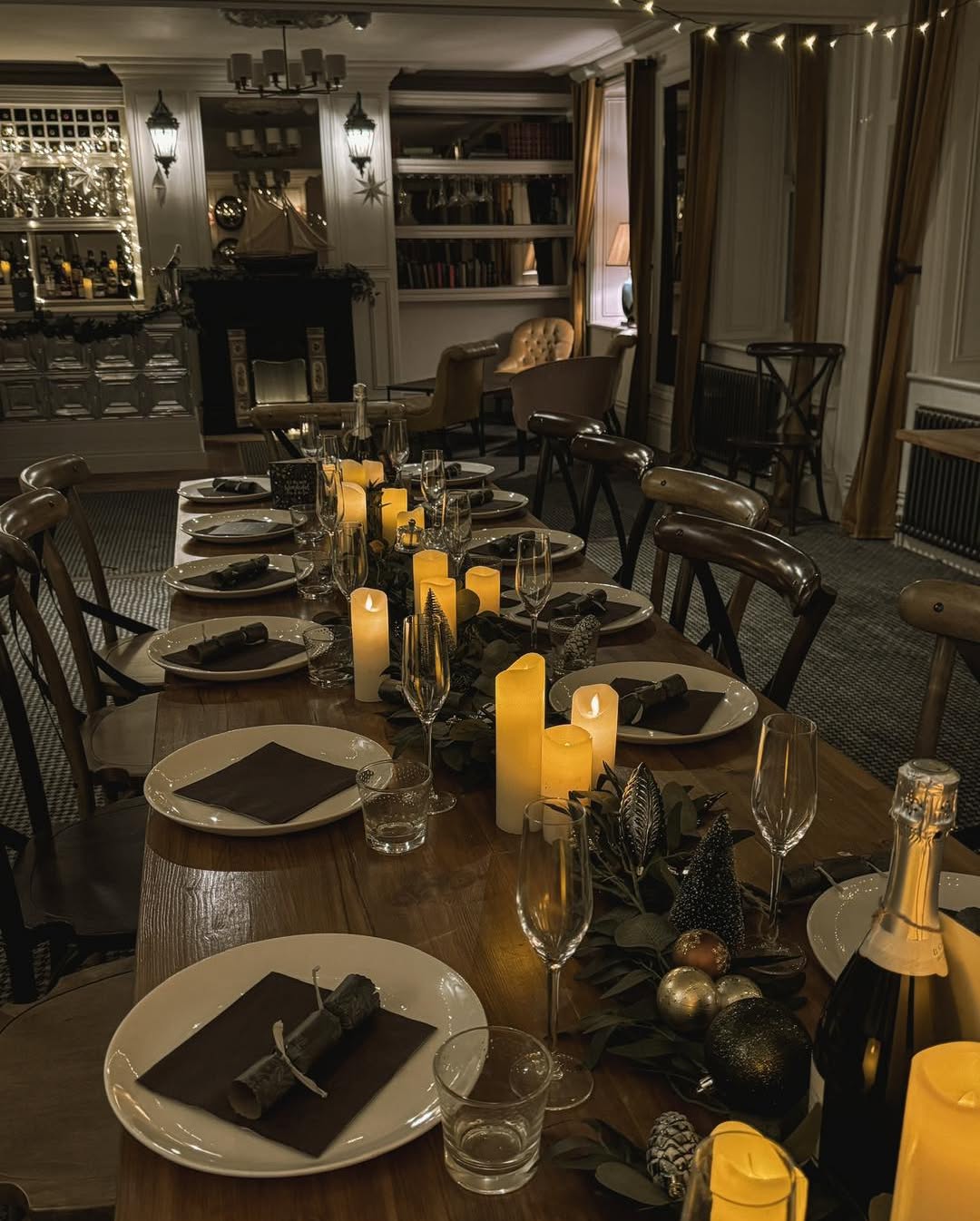 The Bay View Room set for a festive gathering with candles, greenery and Christmas decorations