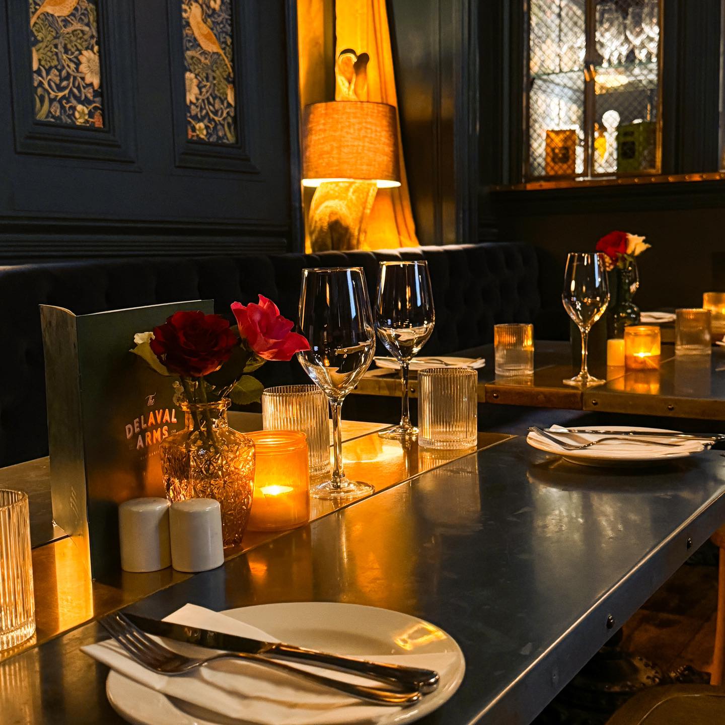 Candlelit tables set for dinner in the Delaval Arms dining room