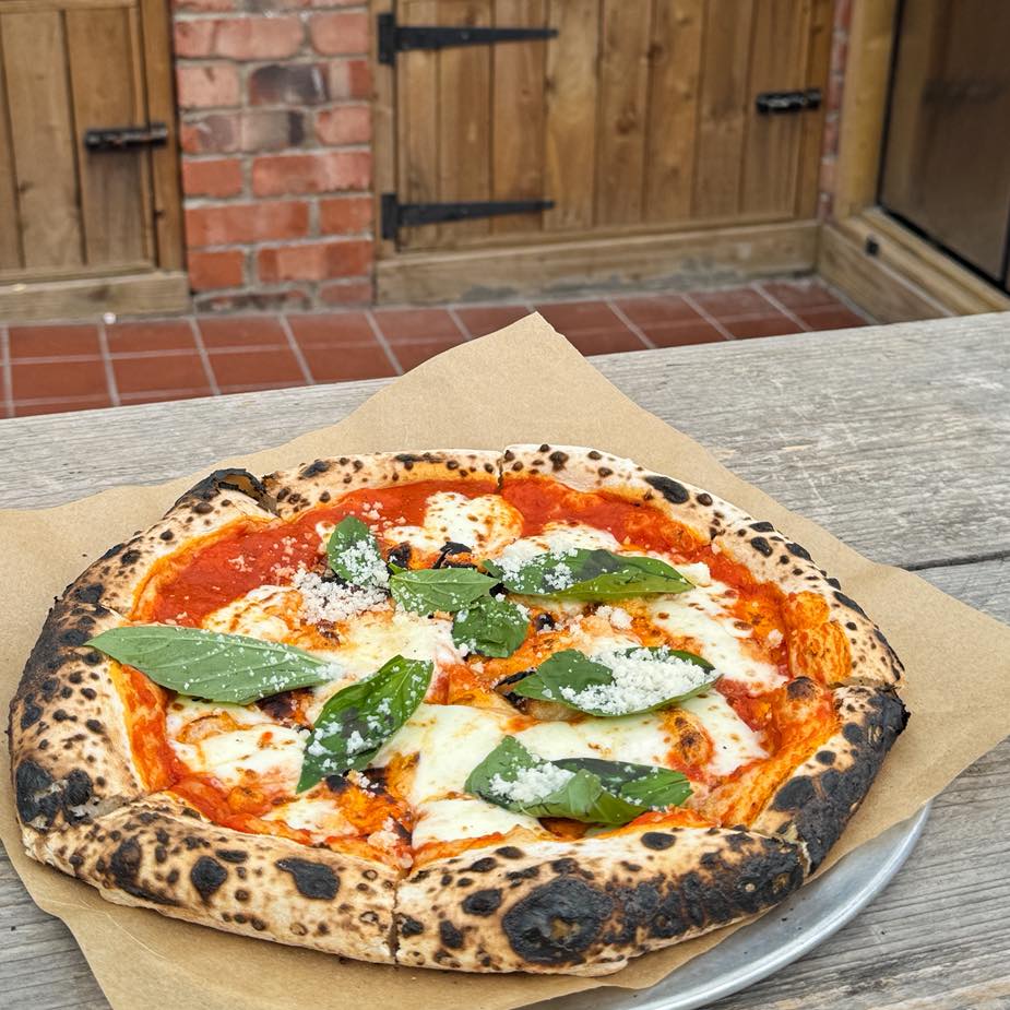 Pizza served at a garden table at the Delaval Arms