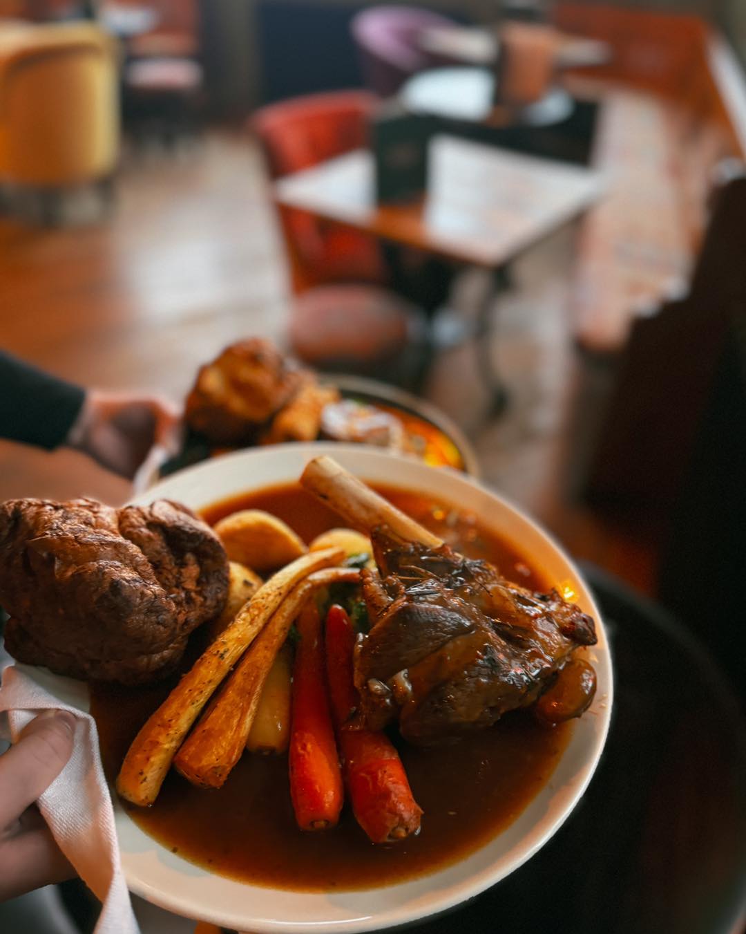 A Delaval Arms lamb shank roast being served inside the pub